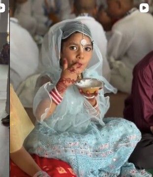 Child receiving prasadam at Radhe Kunj, Vrindavan.